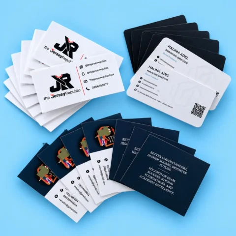 Business Card Printing - 300gsm & 600gsm Fanned-out stacks of custom printed business cards with rounded corners displaying logos, contact details, and QR codes against a bright blue background.